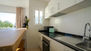 a kitchen with a sink and a counter top at Tabbu ibiza apartments in Playa d'en Bossa