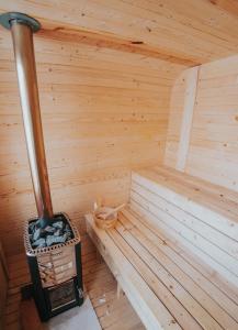 a sauna with a woodburning stove in a cabin at Acasă Straja - Casa Nordică in Lupeni +22 photos