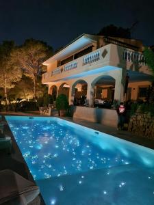 a swimming pool in front of a house at night at Villa Es Pont, bis 10Pers, BBQ in Son Vida