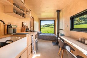 a tiny house with a view of a bedroom at Off-grid, Eco Tiny Home Nestled In Nature in Alton Pancras