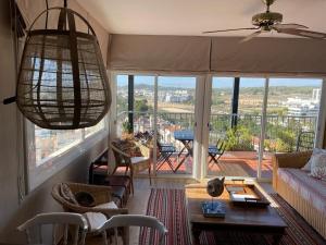 a living room with a view of a balcony at Sea Views Penthouse in Sitges