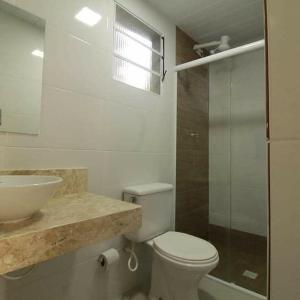 a bathroom with a toilet and a sink and a shower at Toca do Capitao in Boicucanga +32 photos