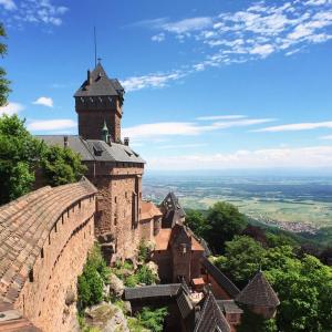 a castle on top of a hill with a tower at MOBIL HOME familiale EN ALSACE11 KM DES GRANDS PARCS in Boofzheim
