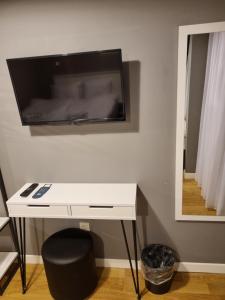 a white desk with a television on a wall at Utarit Hotel in Istanbul