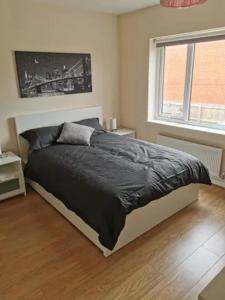 a bedroom with a bed and a window at Entire 3 bedroom house Manchester free parking in Manchester