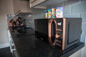 a microwave oven sitting on a counter in a kitchen at Withnell Stays - Apartment Three in Blackpool