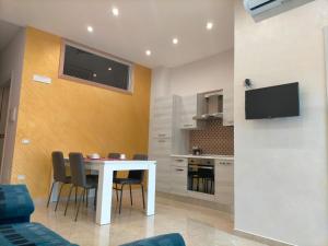 a living room with a white table and chairs at SCENU' in Martina Franca