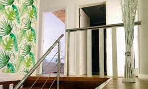 a staircase in a house with a mural on the wall at Alo Baía São Lourenço in Santa Bárbara
