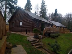 a log cabin with a porch and a deck at Charming lodge cosy comfortable ideal location in Blairgowrie