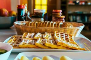 a basket of waffles sitting on top of a table at Cinnamon Sally Backpackers Hostel in Riga