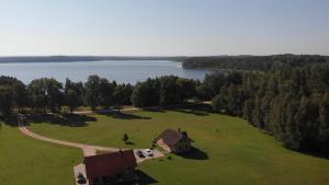 an aerial view of a house on a field next to a lake at Guest House Unguri in Stalbe