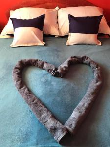 a heart made out of a blanket on a bed at Gemini apartman in Hajdúszoboszló