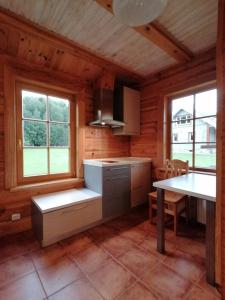 a kitchen with a table and a dining room at Guest House Unguri in Stalbe