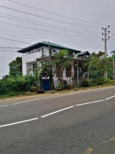 a house sitting on the side of a road at Cottage Home Belihuloya in Balangoda