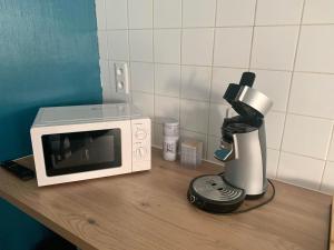 a microwave and a coffee maker on a counter at Gites des Lavandières in Cour-Cheverny