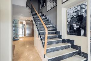 a staircase in a home with a black and white photo on the wall at Hostal Parque Ibiza in Ibiza Town
