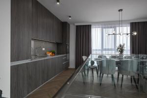 a kitchen and dining room with a table and chairs at The Penthouse in Ahtopol