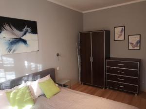 a bedroom with a bed and a dresser at Apartament Marzenie 10 - Opole in Opole