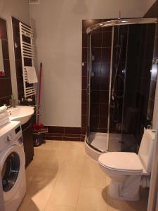 a bathroom with a shower and a toilet and a sink at Apartament Marzenie 10 - Opole in Opole +3 photos