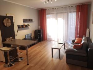 a living room with a couch and a table at Apartament Marzenie 10 - Opole in Opole