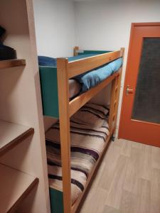 a bunk bed in a room with some blankets at Le Guisanel in Briançon