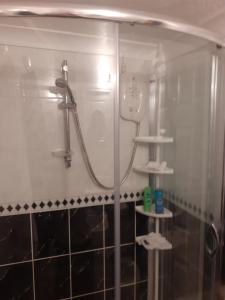 a bathroom with a shower with a mirror at Seaview Cottage 24 Freeman Street in Wells next the Sea