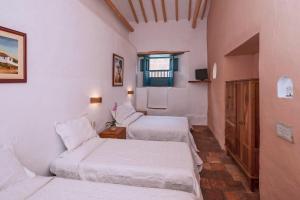 Postel nebo postele na pokoji v ubytování Posada del Campanario