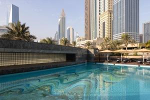 a large swimming pool in the middle of a city at Jumeirah Emirates Towers in Dubai