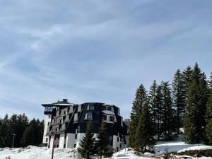 a large building on top of a snow covered mountain at Vili.Kop studio in Kopaonik