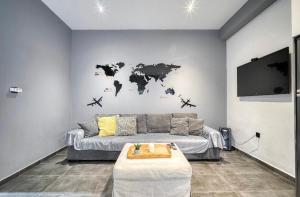 una sala de estar con sofá y un mapa mundial en la pared en L apartment, en Atenas