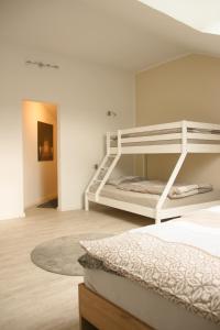 a bedroom with two bunk beds and a rug at Gästehaus Mittendrin in Dahn