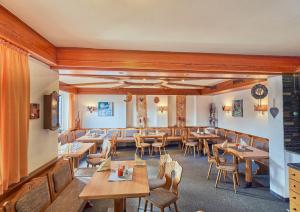 a dining room with wooden tables and chairs at Landhotel Krone in Oberreute