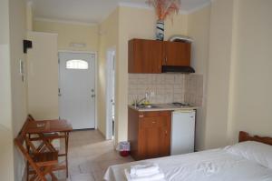 a room with a kitchen with a bed and a sink at Despina Studios Raxes Ikaria # 1 in Raches
