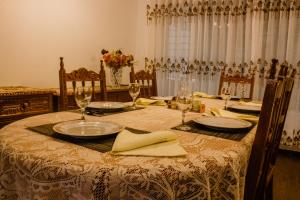 a dining room table with plates and glasses on it at Casa Libertad in Cusco