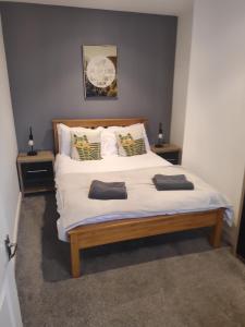 a bedroom with a large bed with two pillows on it at Buller View in York