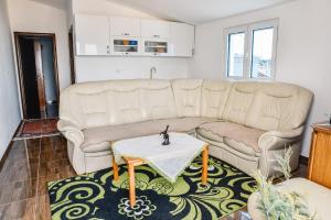 a living room with a couch and a table at Seaview Apartments Bonaca in Bar +26 photos
