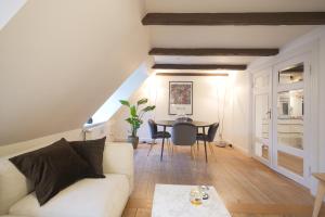 a living room with a white couch and a table at Admiral's Apartment IV - Carolina's apartments in Copenhagen