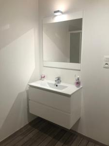 a white bathroom with a sink and a mirror at Joli T2 récent 'Le VIVALDI' in Ajaccio