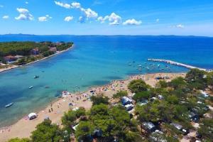 an aerial view of a beach with people in the water at M&M Mobile home in Privlaka