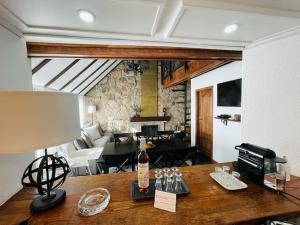 a table with a bottle of wine on top of a room at Juniper Star House - Penhas da Saúde,Serra Estrela in Cortes do Meio