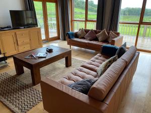 a living room with two couches and a coffee table at 22 Drumcoura Lake Resort Holid in Ballinamore