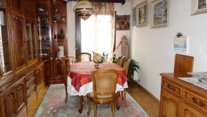 a dining room with a table with chairs and a window at Les Naïades in Gérardmer