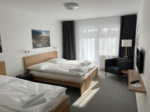 Katil atau katil-katil dalam bilik di Hotel VARNSDORF