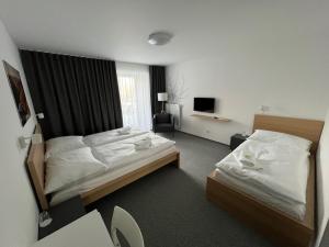 Katil atau katil-katil dalam bilik di Hotel VARNSDORF
