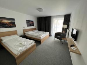 Katil atau katil-katil dalam bilik di Hotel VARNSDORF