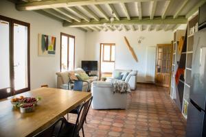 a living room with a table and a couch at Le saint michel in Orpierre