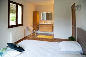 a bedroom with a large bed and a sink at Le saint michel in Orpierre