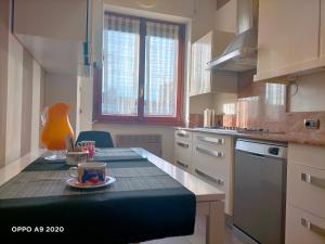 a kitchen with a table with a coffee cup on it at Appartamento La Ninfea in Arona