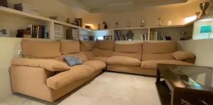 a living room with a couch and a glass table at VILLA Bed and Breakfast - kitchen, Pool, Barbecue and Large garden in Benidorm