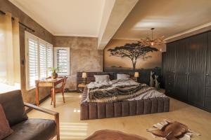 a bedroom with a large bed and a table at YEBO Boutique Guesthouse in Somerset West +79 photos